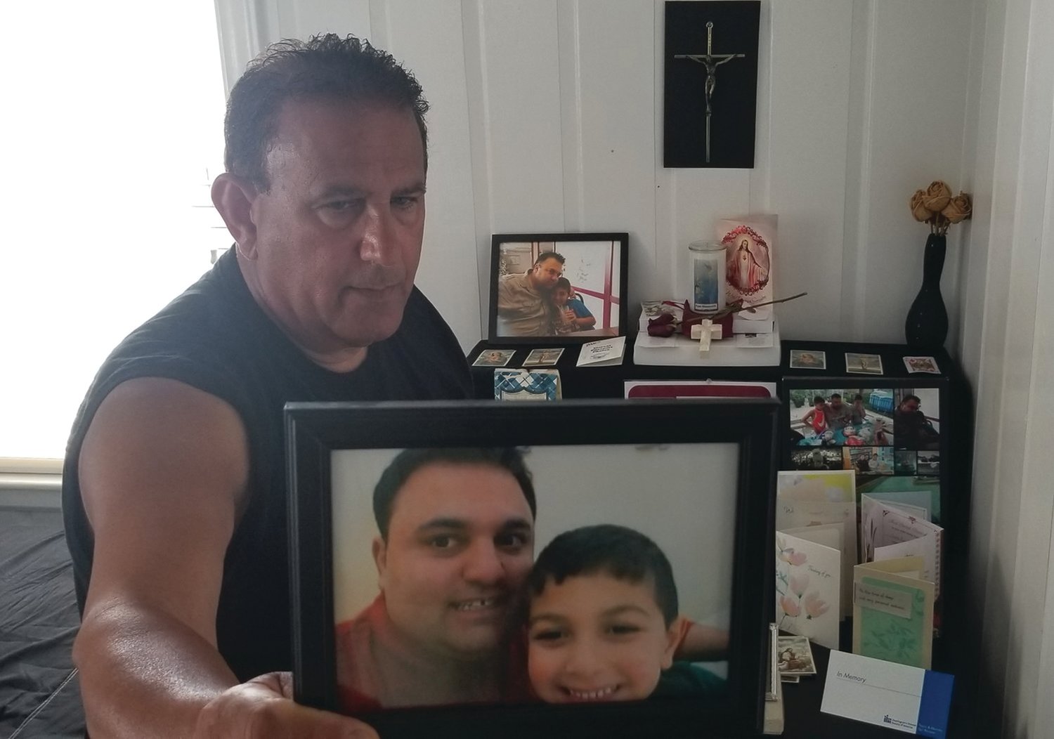 PRODUCTIVE GRIEF: Louis Massemini holds a photo of his son, Louis Ryan Massemini, and grandson Carmen. Ryan died of an overdose in 2019. His father has worked on legislation aimed at preventing similar deaths.